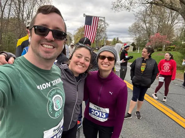 Runners gathered at the Northmen 5K finish line with an American flag