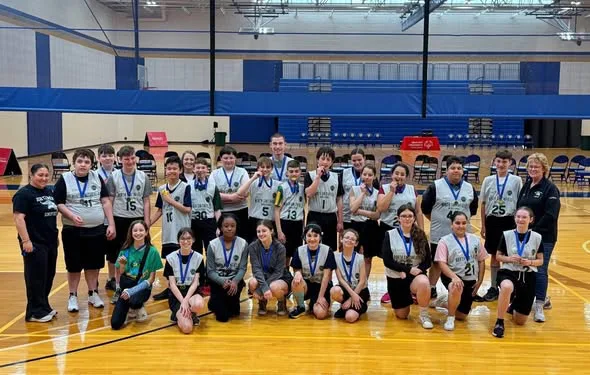 North Smithfield Unified Sports team with medals in the gym